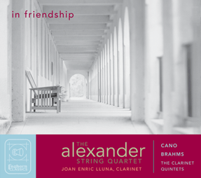 Cover art for In Friendship shows an old mission colonnade, with a wooden bench in profile and arched doorway at the far end, photo by Rory Earnshaw